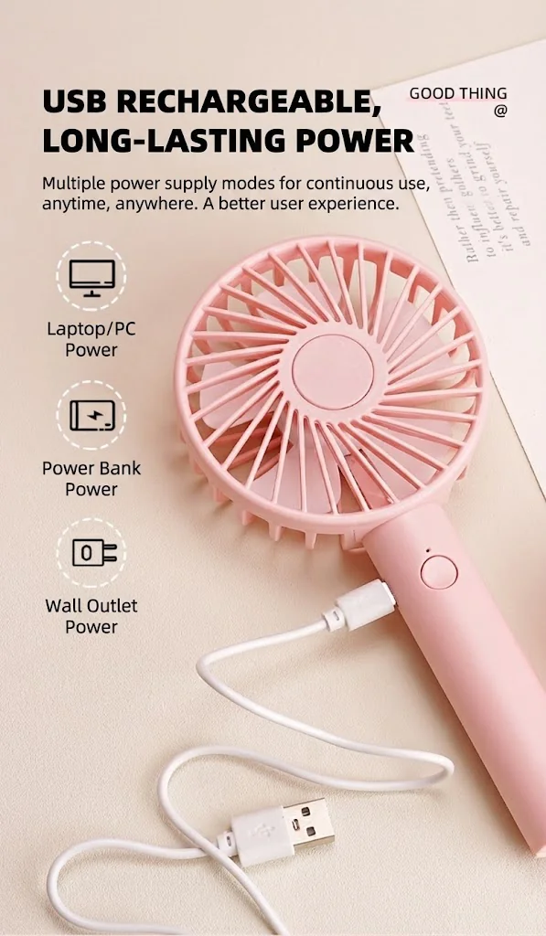 Pink mini fan charging with USB cable